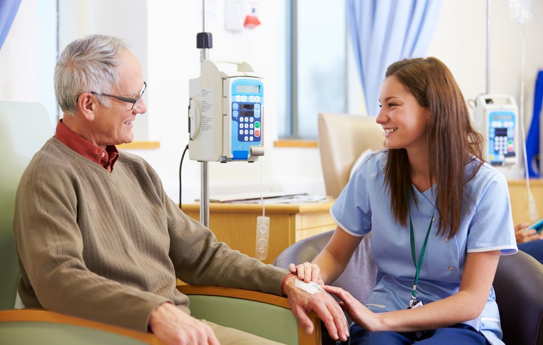 man talking with oncologist about GI Cancers and Colorectal Cancer treatment